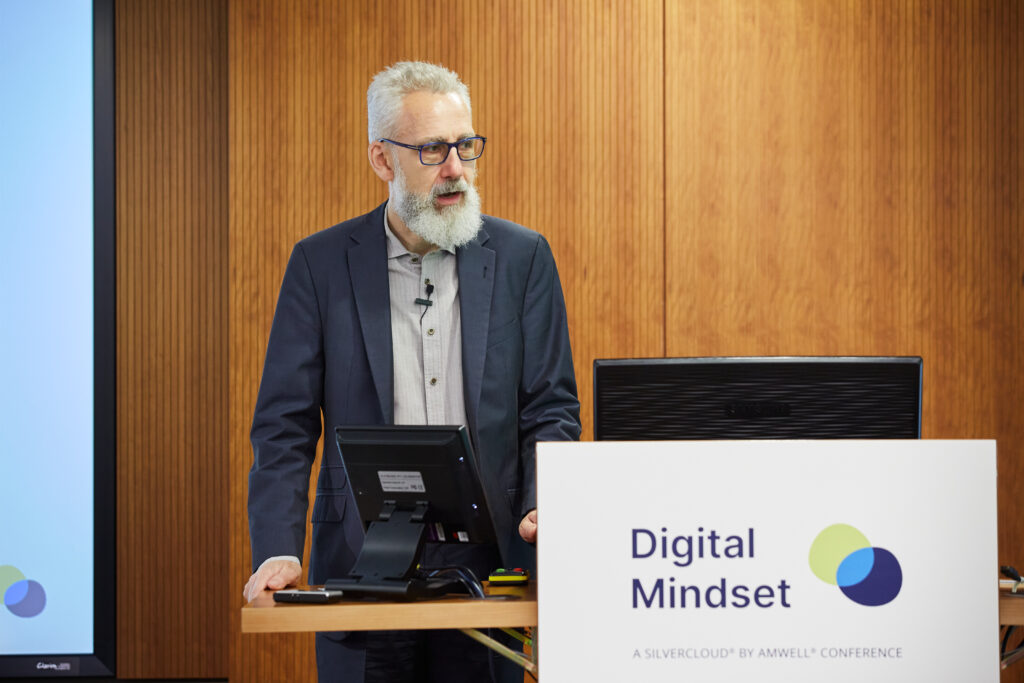 Key stakeholders Alastair McLellan at podium for the Digital Mindset event for digital mental health by silvercloud, showcasing the power of events in healthcare PR.