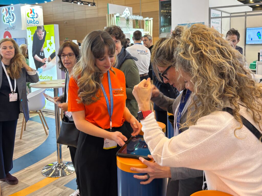 Lily Spencer on medtech event congress stand with gamified engagement activity and a busy stand